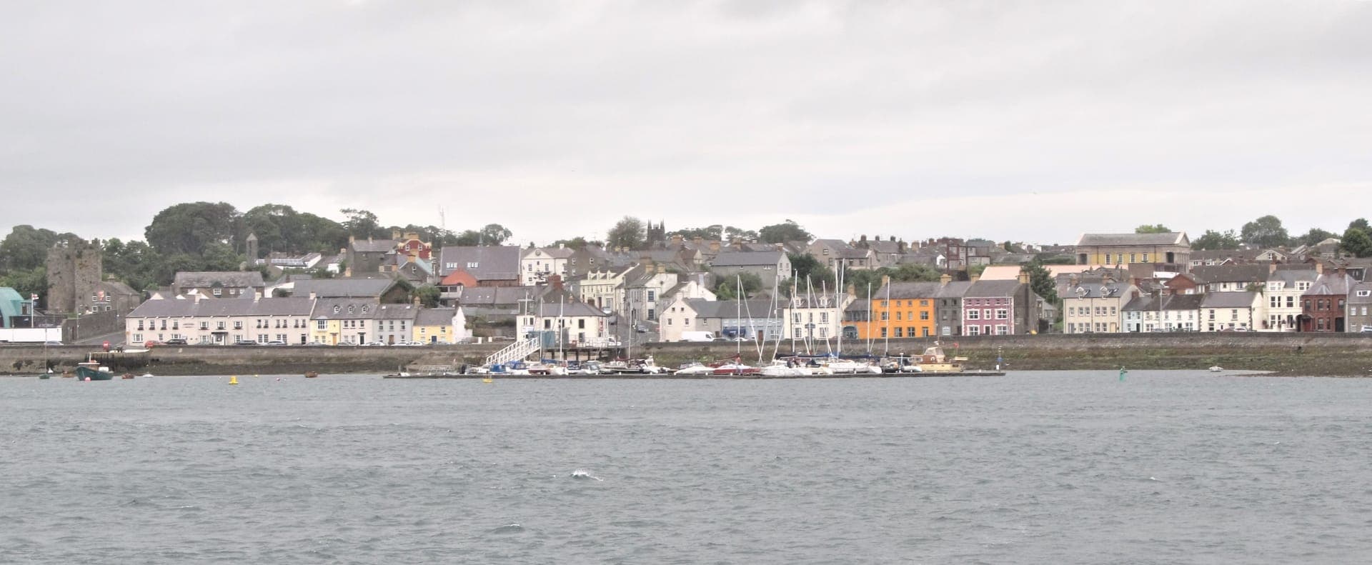 Winding coastal road with Mourne Mountains meeting the Irish Sea